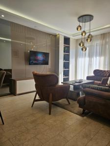 a living room with a table and a couch at Miss Extra LuX in Mladenovac