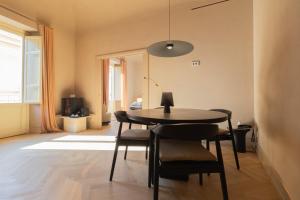 a dining room with a table and some chairs at Palazzo Balsamo Boutique Hotel in Palermo