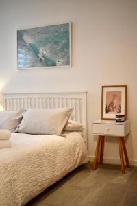 a bedroom with a bed and a picture on the wall at Private room and bathroom in shared flat with parking in Glasgow