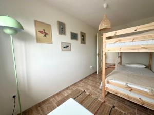 a bedroom with a bunk bed and a lamp at Apartamento Balea - San Vicente do Mar in Balea