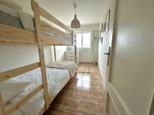 a bedroom with two bunk beds and a hallway at Apartamento Balea - San Vicente do Mar in Balea