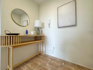 a room with a mirror and a table with a lamp at Apartamento Balea - San Vicente do Mar in Balea +4 photos