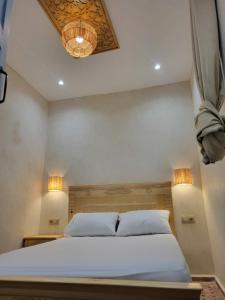 a bedroom with a bed with two white pillows at Quiet coastal house in the heart of Essaouira in Essaouira