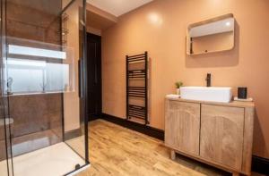 a bathroom with a shower and a sink and a mirror at Our Home from Home in the heart of Abergavenny in Abergavenny +35 photos