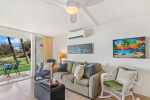 a living room with a couch and a table at Keawakapu 208 · KKP 208 Renovated Condo w AC Near Beach Shops in Wailea