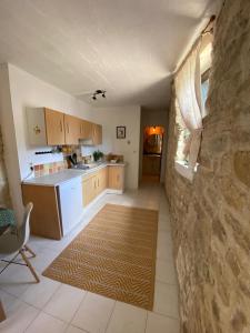 a kitchen with a counter and a table and a rug at Self contained Guest House in Juillé in Juille