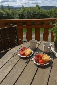 two plates of food sitting on a wooden table at Haus Waldblick in Winterberg +31 photos