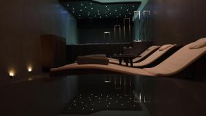 a room with a row of chairs and a table at Paint It Black Hotel & Spa in Gevgelija