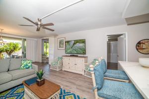 a living room with a couch and a tv at Eldorado E104 · Spacious 1BD wPool at Kaanapali in Kahana