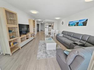 a living room with a couch and a table at Seaside Sovereign Retreat in Caloundra