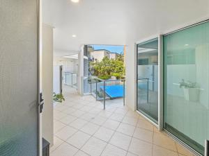 an empty corridor of a building with a balcony at Seaside Sovereign Retreat in Caloundra