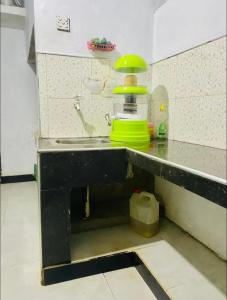 a kitchen with a counter with a green lamp on it at Heart Whispering in Kandy