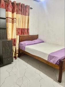 two twin beds in a room with a window at Heart Whispering in Kandy