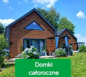 a wooden house with the words donk cottorage at Eleonor Accommodation exclusive house in Liszki