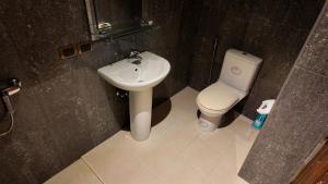 a bathroom with a white toilet and a sink at Modern apartment in Patong Center in Ban Nong Chaeng