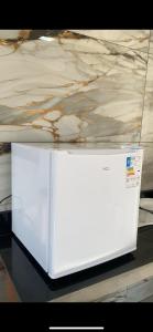 eine weiße Mikrowelle auf einem Tisch in der Unterkunft Chalé Por do Sol in Caparaó Velho