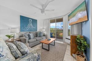 a living room with a couch and a table at Maui Banyan P301 · MB P301 Remodeled 2BD Condo Across Beach Pool in Wailea