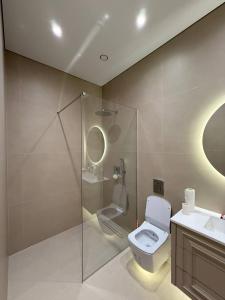 a bathroom with a shower and a toilet and a sink at Symphony Boutique in Tashkent +54 photos