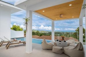 a living room with a view of the ocean at Villa Orchidée Infinity pool & sea view 3BR in Amphoe Koh Samui