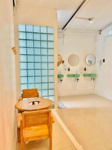 a bathroom with a sink and a wooden chair at Lazy Sunday Khaosan Hotel in Bangkok