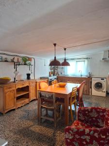 a kitchen with a wooden table and a dining room at Casa Cerca del cielo in El Chorro
