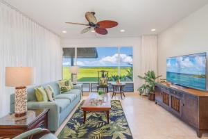 a living room with a couch and a flat screen tv at Kapalua Bay Villas 35G1 · KBV 35G1 Luxury Kapalua Villa w AC Poo in Kahana