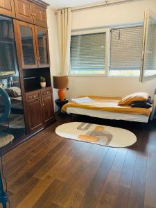a bedroom with two beds and a rug on the floor at Chambre à louer dans un panthause in Bourg-la-Reine