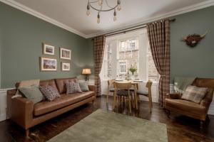 a living room with a couch and a table at Rose Apartment in Edinburgh