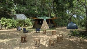 a tent and chairs and tables in front of a tent at RedBrick House Rumassala in Galle