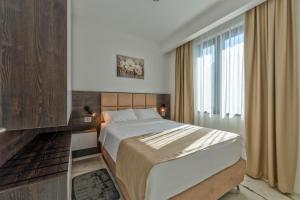 a bedroom with a large bed and a window at Villa Di Montagna wellness & spa in Zlatibor +73 photos