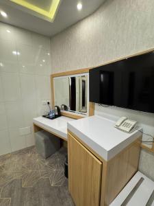 an office with a desk with a phone and a computer at Rose Land Hotel in Umm Lujj