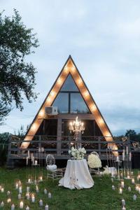a tent with a table and chairs in the grass at Soul House in Pilipets