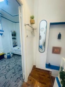 a room with a mirror and a surfboard on the wall at Ibn Batouta House in Tangier