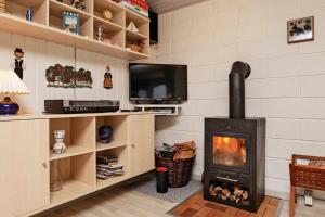 a living room with a fireplace and a tv at Charming 4-Person Holiday Home in Ls, Denmark in Vesterø Havn