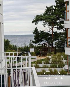 a view of the ocean from the balcony of a building at Gold Apartment E47 Studio Let's Sea Baltic Park Gąski in Gąski +114 photos