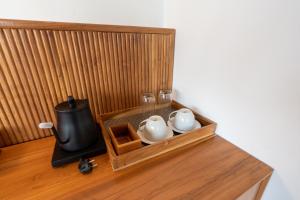 a wooden box with two tea pots and a stove at KAPI Sebatu Villa in Tampaksiring