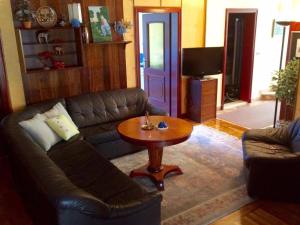 a living room with a couch and a table at Guest House Vila Eli in Herceg-Novi