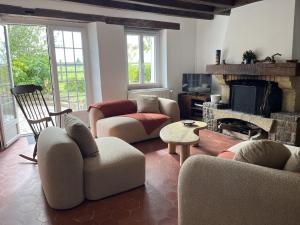 a living room with couches and a fireplace at L'Oiselière - Campagne - Proche circuit - 5p in Mulsanne