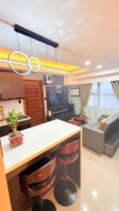 a kitchen with a island with bar stools and a living room at LM50L2 horizon101 cebu in Cebu City