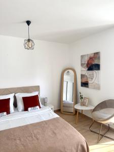 a bedroom with a bed and a table and a mirror at Danin apartmani in Bar