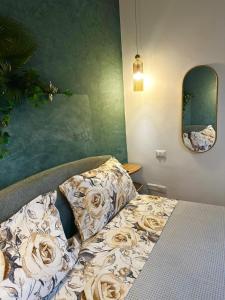 a bedroom with a bed with flowers on it at Le Stanze di Bimba in Terni