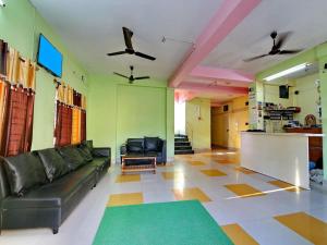 a living room with a couch and a table at Hotel Cosy Inn in Digha