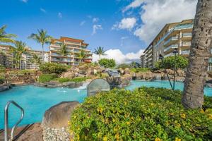 a pool in a resort with a water slide at Honua Kai K1024 · HK K1024 Kaanapali Beach Condo Resort Living R in Lahaina