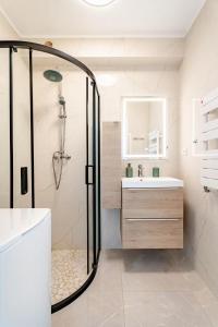 a bathroom with a shower and a sink at Luxury Apartment with Sea View and Private Beach Access in Cannes