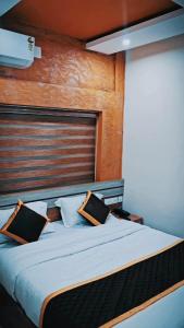 a bedroom with a large bed with a wooden headboard at Radission in Padinjarathara +12 photos
