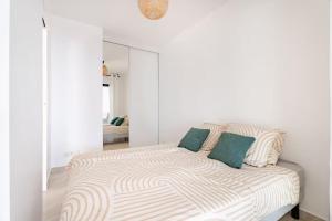 a white room with a bed with a mirror at Luxury Apartment with Sea View and Private Beach Access in Cannes
