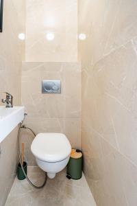 a bathroom with a toilet and a sink at Luxury Apartment with Sea View and Private Beach Access in Cannes +18 photos