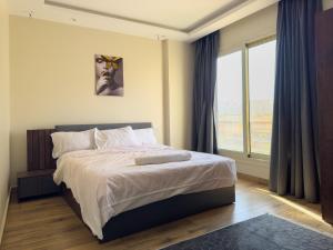 a bedroom with a bed and a large window at 407. Spacious 3BR Apt. 2 Baths Gated Community in Sheikh Zayed