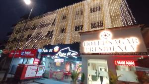 a building with lights on top of it at night at Hotel Sagar Presidency A Unit of Buesoco Hospitality Private Limited in Daman