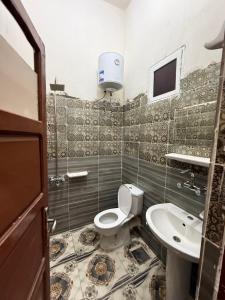 a bathroom with a toilet and a sink at كامب سيوة اواسيس Siwa Oasis Camp in Siwa +45 photos